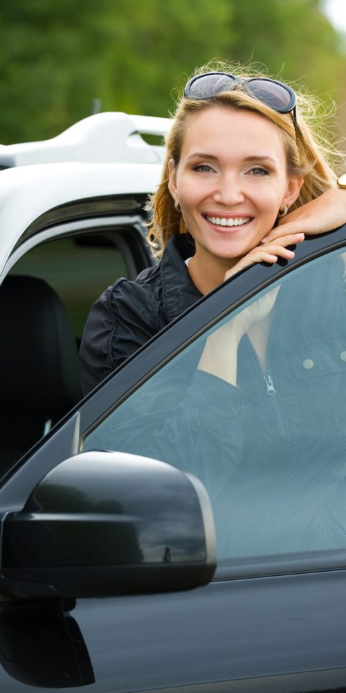 beautiful young happy woman in the new car  - outdoors