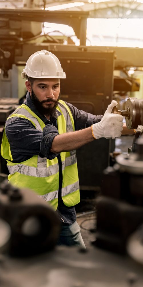 Industrial factory concept. Engineering technician or worker operating and maintenance of machinery.